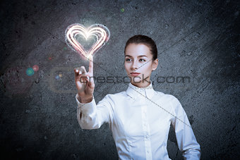 Woman Pointing at Glowing Heart
