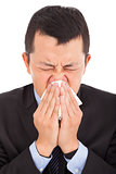 young businessman is sneezing with painful face  