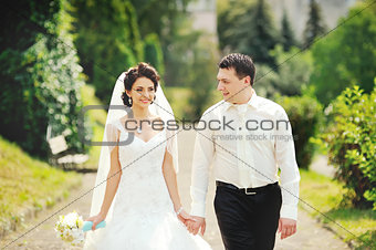 Happy wedding couple walking together