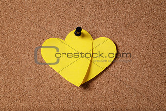 heart shape sticky notes on cork board