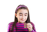 Happy young girl eating chocolate