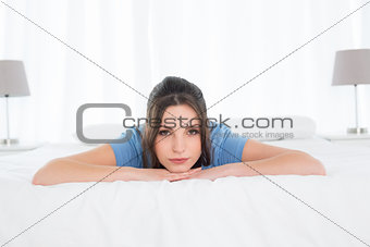Portrait of a pretty woman lying in bed