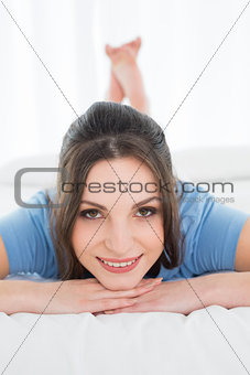 Close-up of a pretty happy woman resting in bed