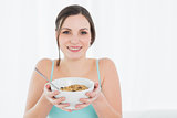 Close-up portrait of a young female with a bowl of cereal