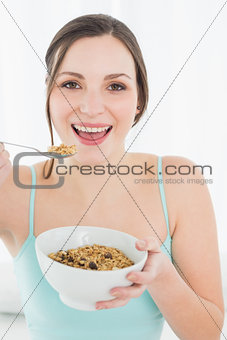 Close-up portrait of a young female with a bowl of cereal