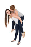 Full length of a young female piggybacking friend