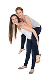 Full length portrait of a young female piggybacking friend