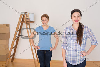 Portrait of female friends standing in a new house