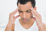 Close-up of a young man suffering from headache