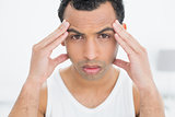 Close-up portrait of a man suffering from headache