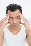 Close-up of a young man suffering from headache