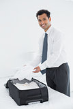 Businessman unpacking luggage at a hotel bedroom