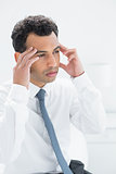 Young businessman suffering from headache