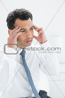 Young businessman suffering from headache