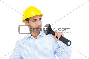 Close-up of a young handyman looking at wrench