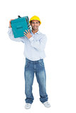Smiling handyman in hard hat carrying a toolbox