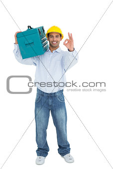 Handyman in hard hat with toolbox gesturing okay sign