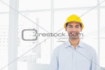 Portrait of a smiling handyman wearing a yellow hard hat