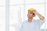 Smiling handyman wearing a yellow hard hat