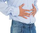Close-up mid section of a casual man with stomach pain