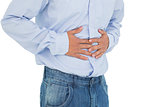 Close-up mid section of a casual man with stomach pain