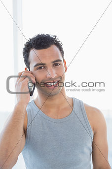 Portrait of a young smiling man using mobile phone