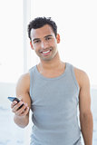Portrait of a young smiling man with mobile phone