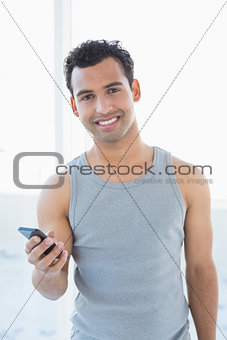 Portrait of a young smiling man with mobile phone
