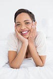 Smiling young woman relaxing in bed