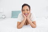 Portrait of a cheerful woman relaxing in bed