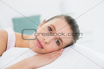 Close-up of a pretty woman relaxing in bed