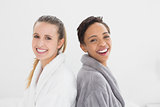 Portrait of two happy female friends in bathrobes