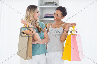 Women standing with shopping bags at home