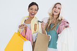 Portrait of cheerful women standing with shopping bags