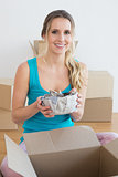 Woman unwrapping boxes in new house