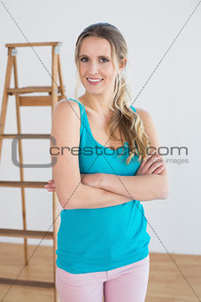 Woman standing against ladder in a new house