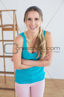 Cheerful woman against ladder in a new house