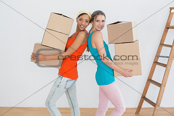 Female friends moving together in a new house