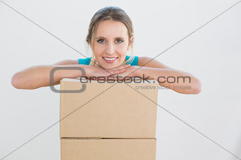 Portrait of a young woman with a stack of boxes