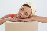 Pretty young woman resting head over boxes