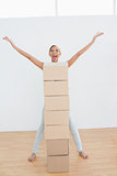 Woman shouting with stack of boxes in a new house