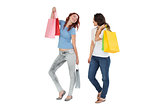 Two happy young female friends with shopping bags