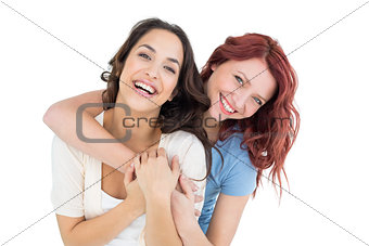 Happy young female embracing her friend from behind