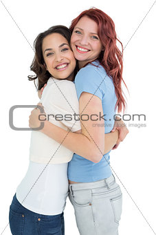 Side view portrait of a young female embracing her friend