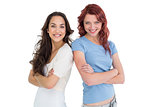 Portrait of two female friends standing with arms crossed