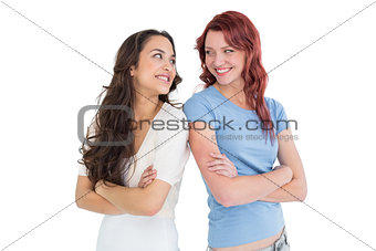 Two female friends standing with arms crossed