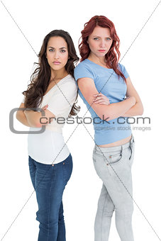 Portrait of two female friends with arms crossed