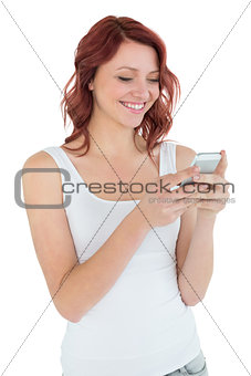 Smiling casual young woman text messaging