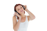 Beautiful casual woman enjoying music through headphones