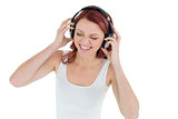 Casual woman enjoying music through headphones
